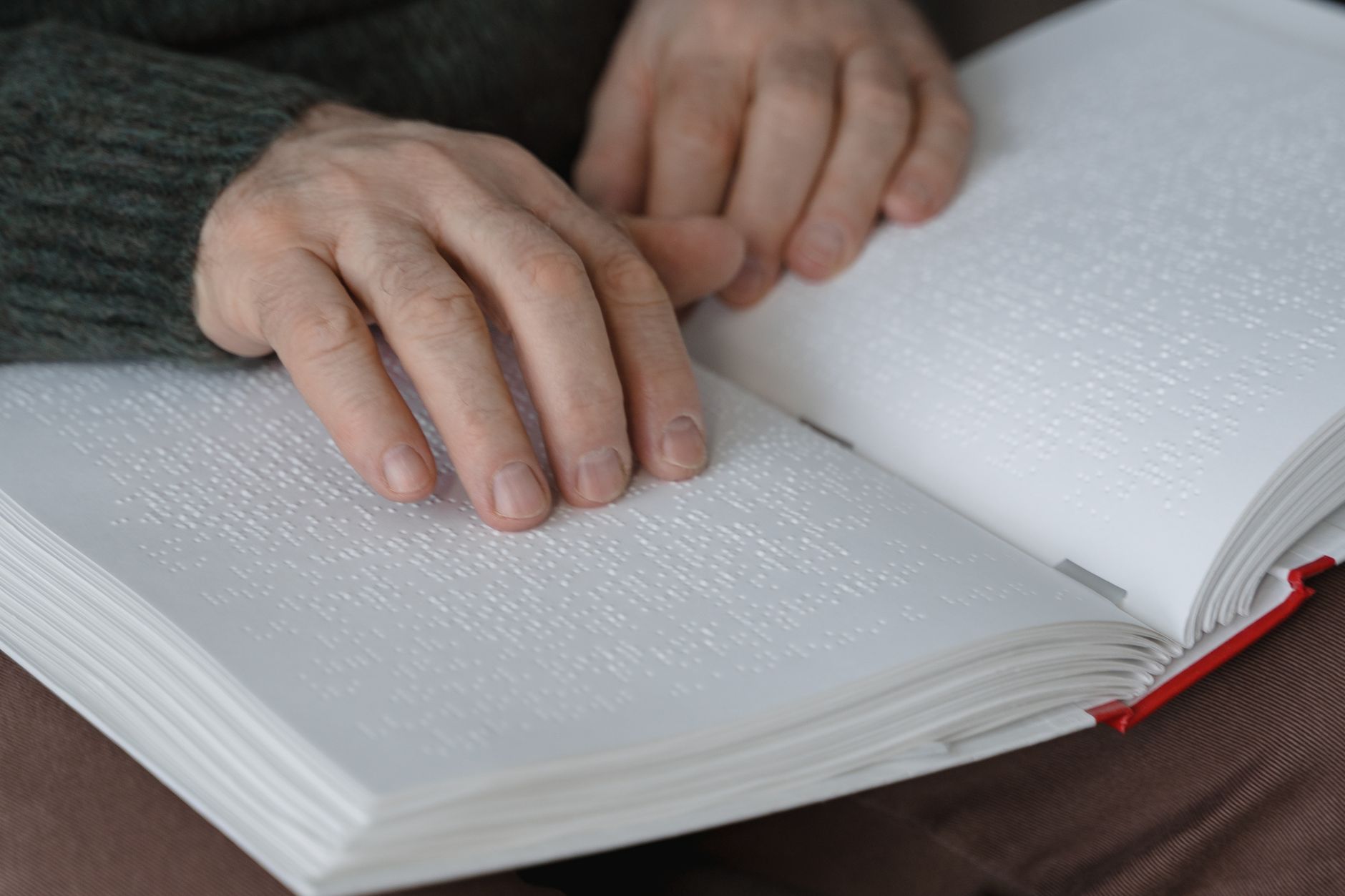 Accessibility professional reviewing a VPAT document on a laptop with WCAG notes