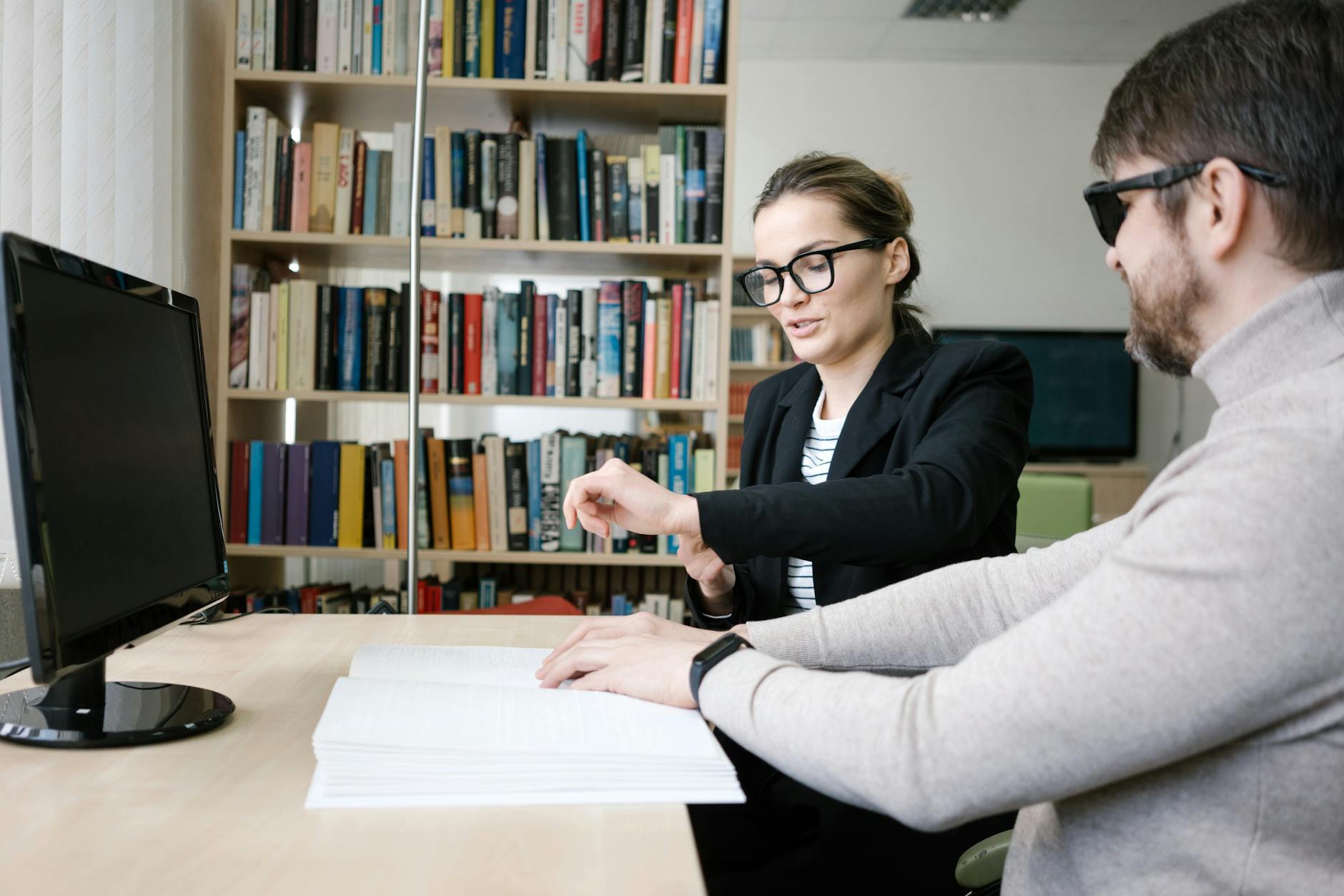 Product team reviewing an accessible website design with contrast and keyboard navigation notes on a laptop