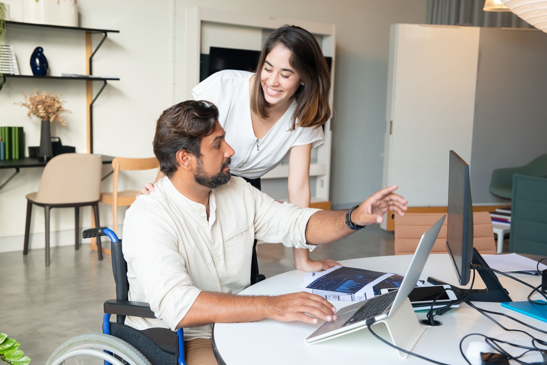 Product team reviewing an accessible website design with contrast and keyboard navigation notes on a laptop