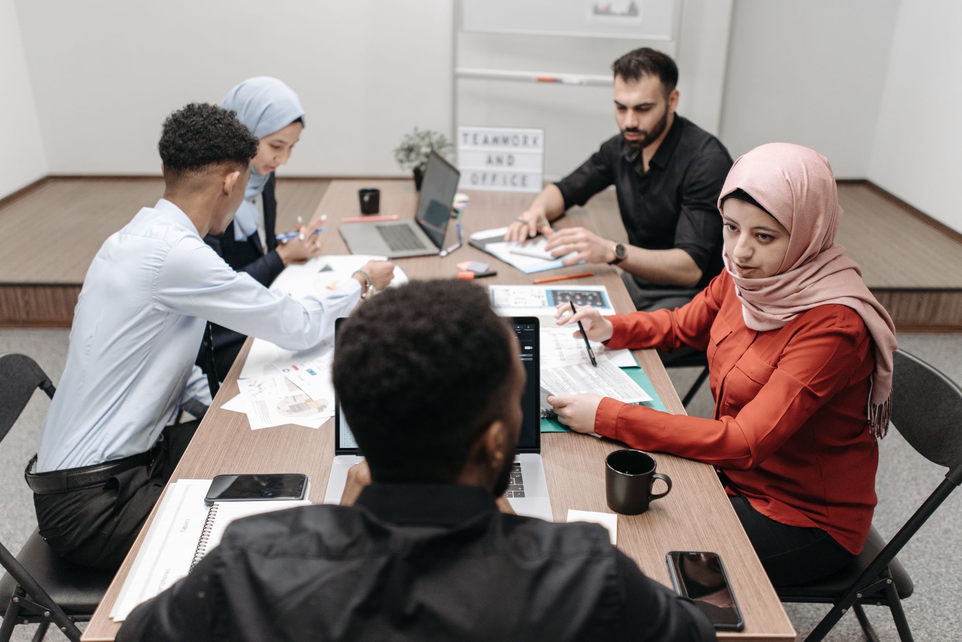 Product team reviewing an AI-driven web interface and accessibility checklist on a large monitor