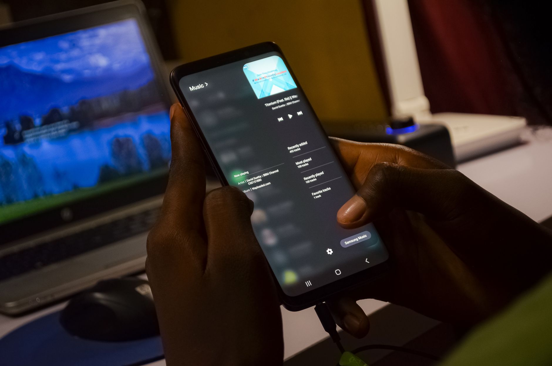 Developer reviewing Android accessibility issues on a smartphone with a checklist on a laptop