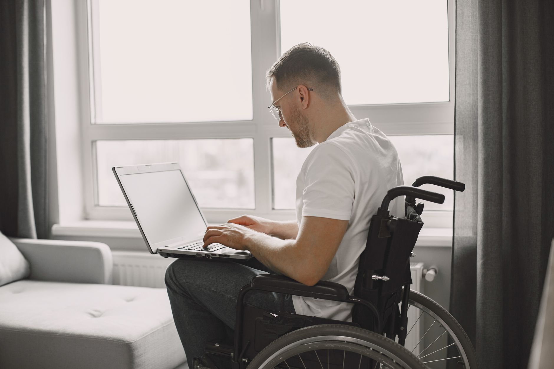 Accessibility specialist reviewing AI-generated accessibility audit results on a laptop