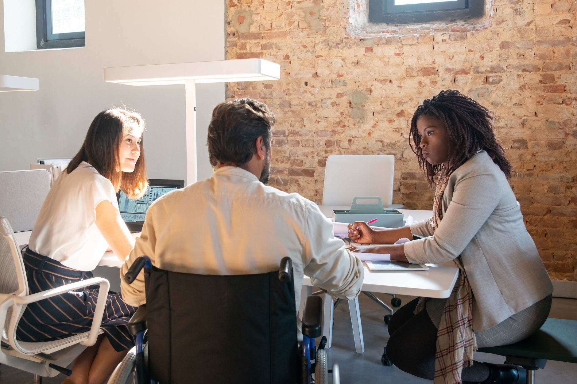 Product team reviewing a web accessibility compliance dashboard on a laptop