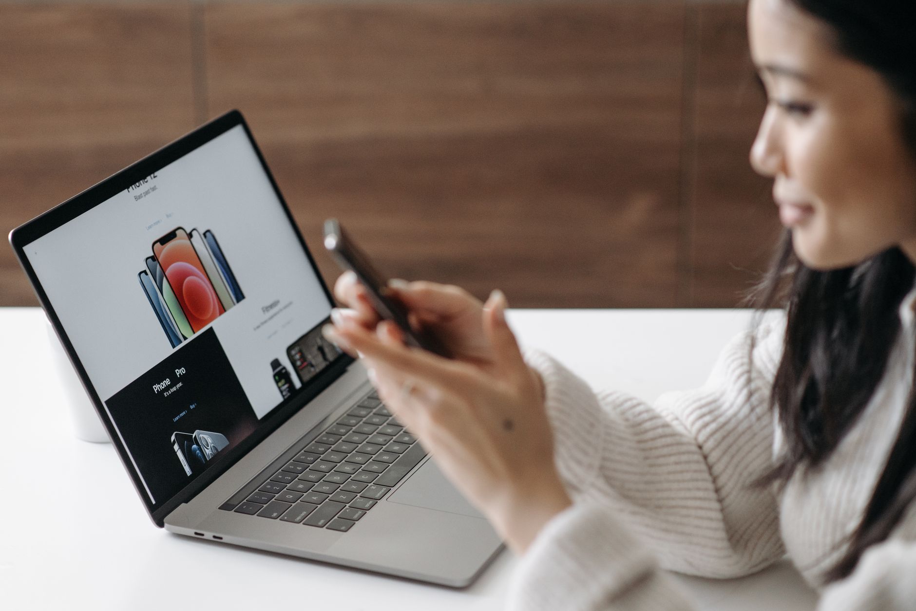 Person reviewing a cookie consent banner interface on a laptop with a compliance checklist beside it