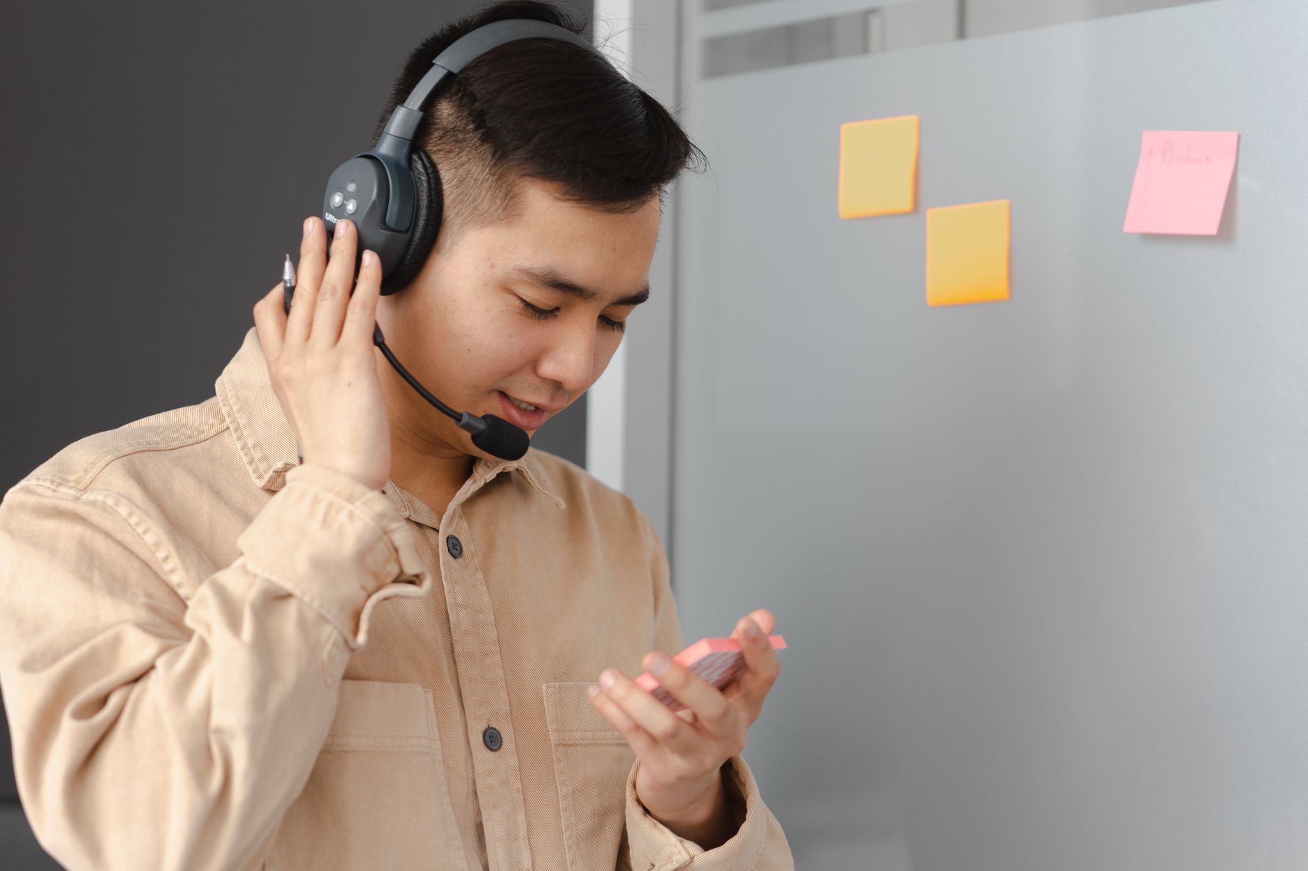 Designer testing accessibility flows across a headset, smart speaker, and mobile app