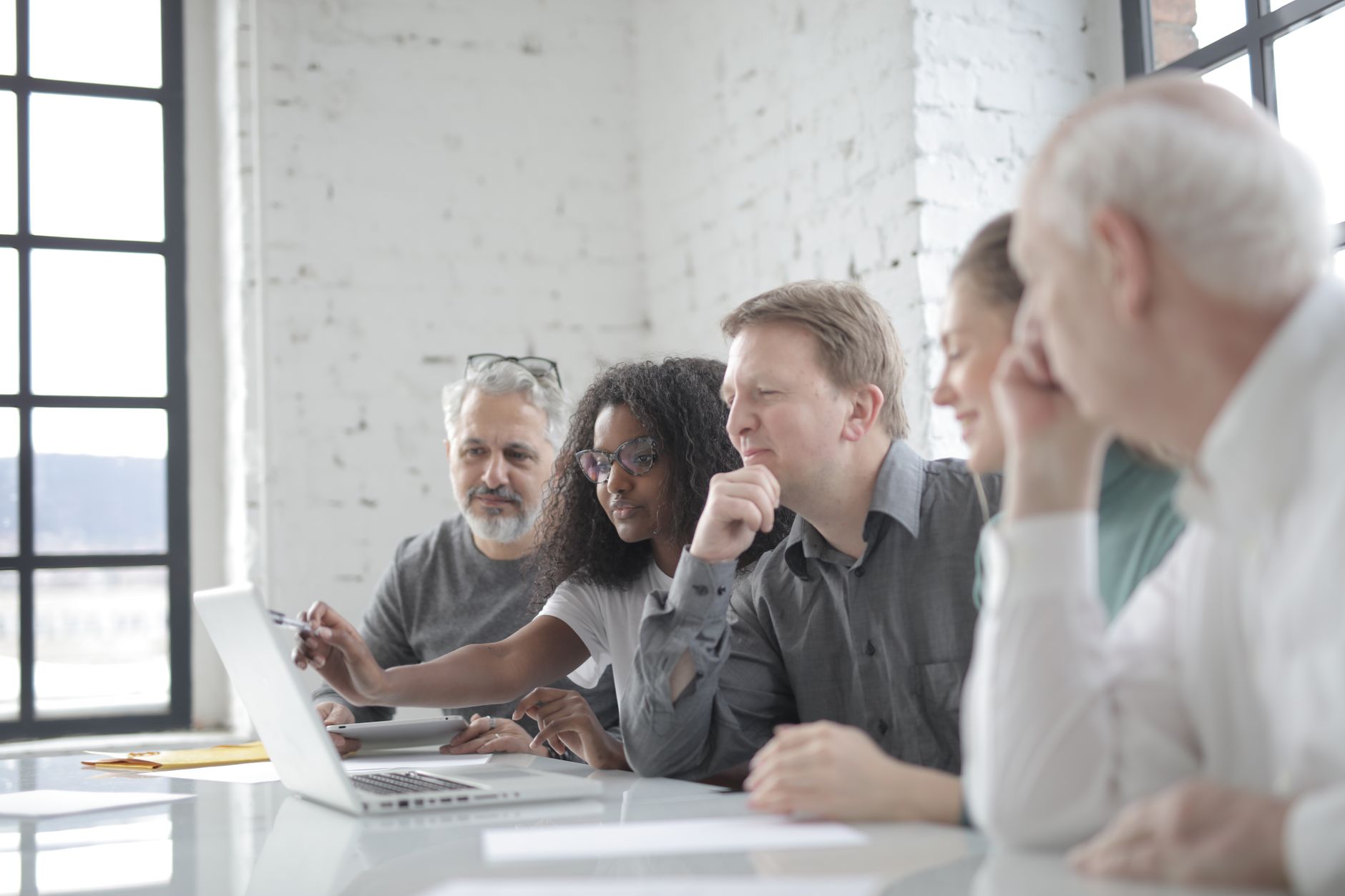 Public sector staff reviewing a government website accessibility checklist on a laptop