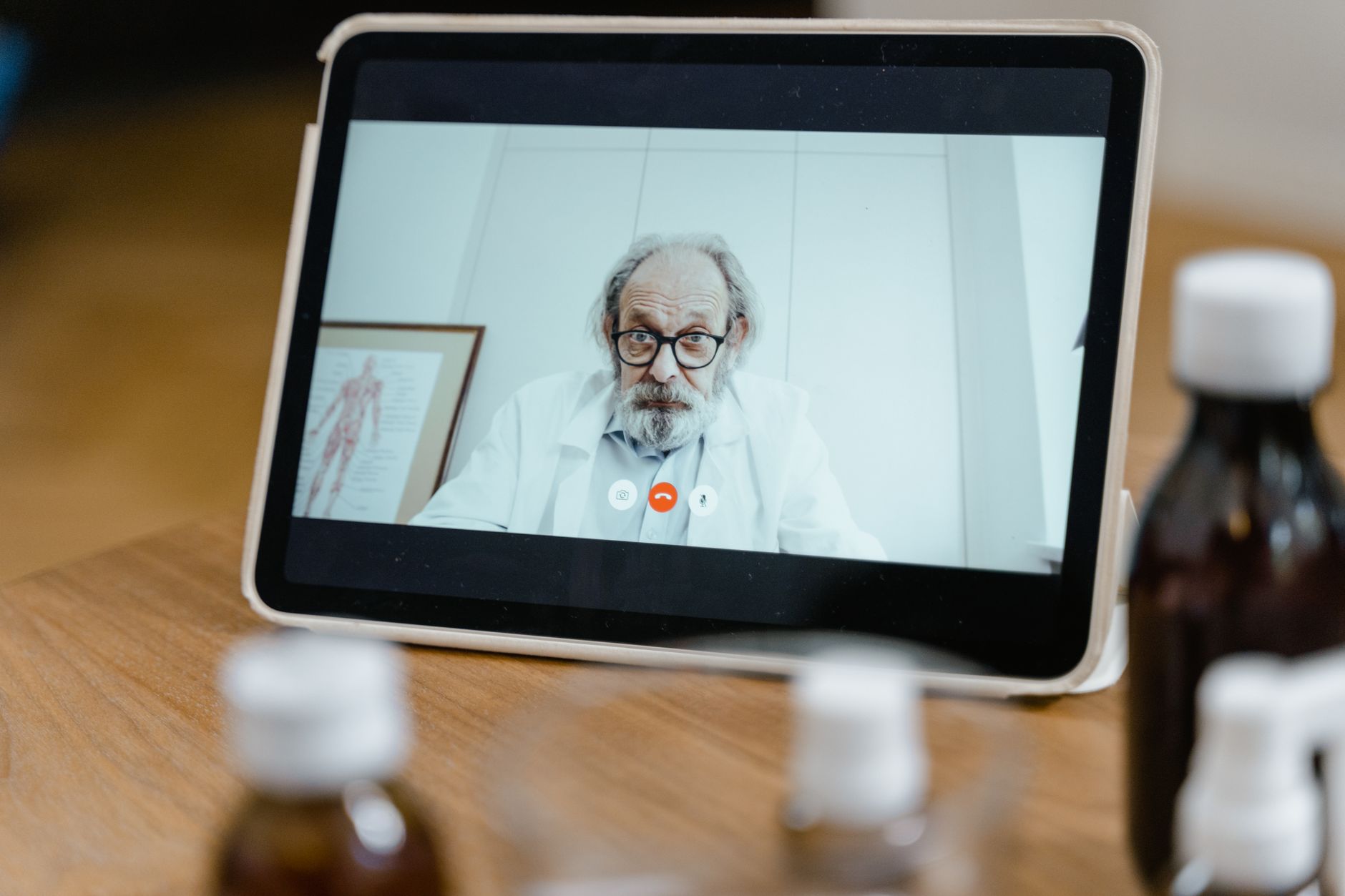 Clinician helping a patient use a tablet to access a patient portal in a hospital setting