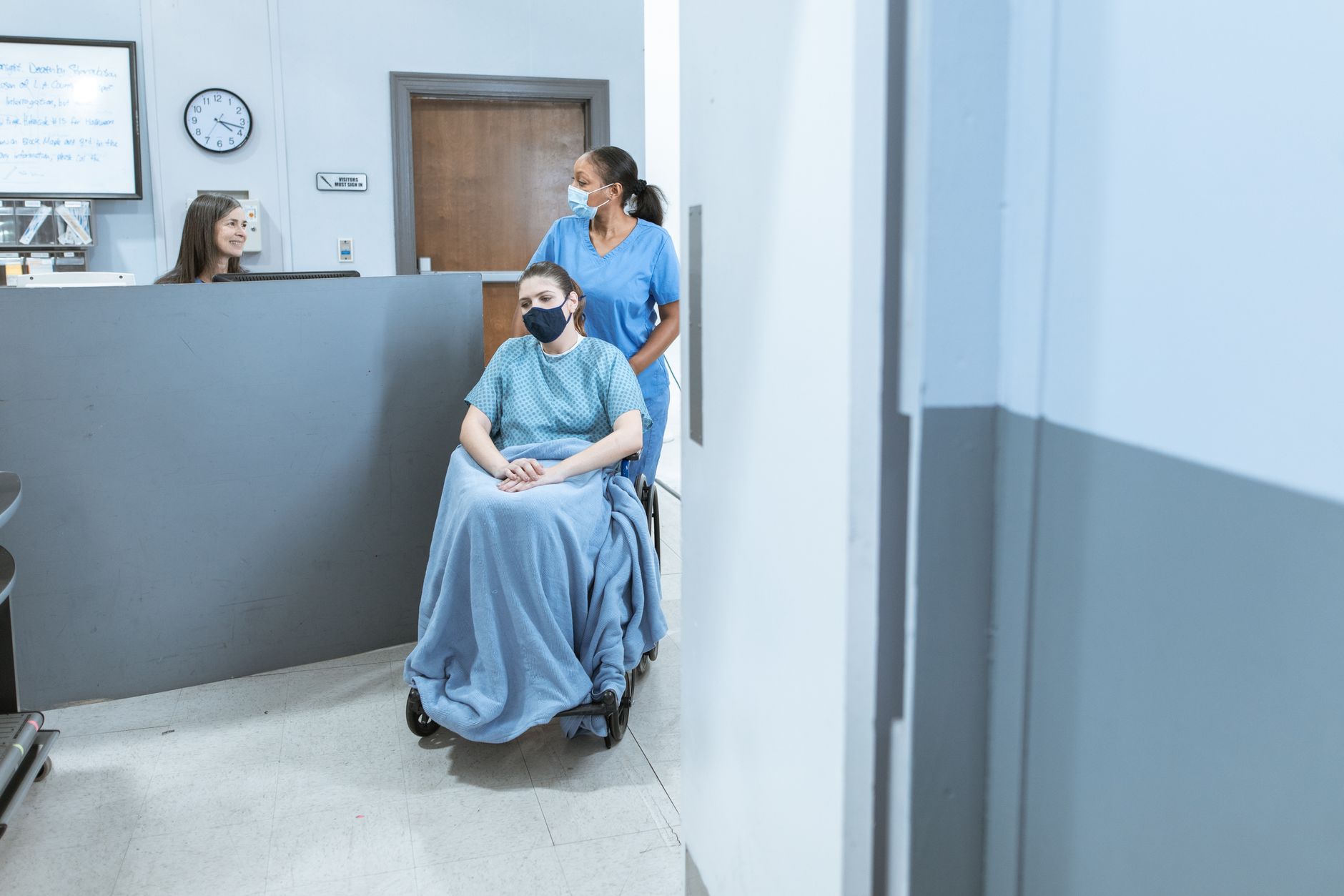 Patient using an accessible hospital website on a tablet with a caregiver nearby
