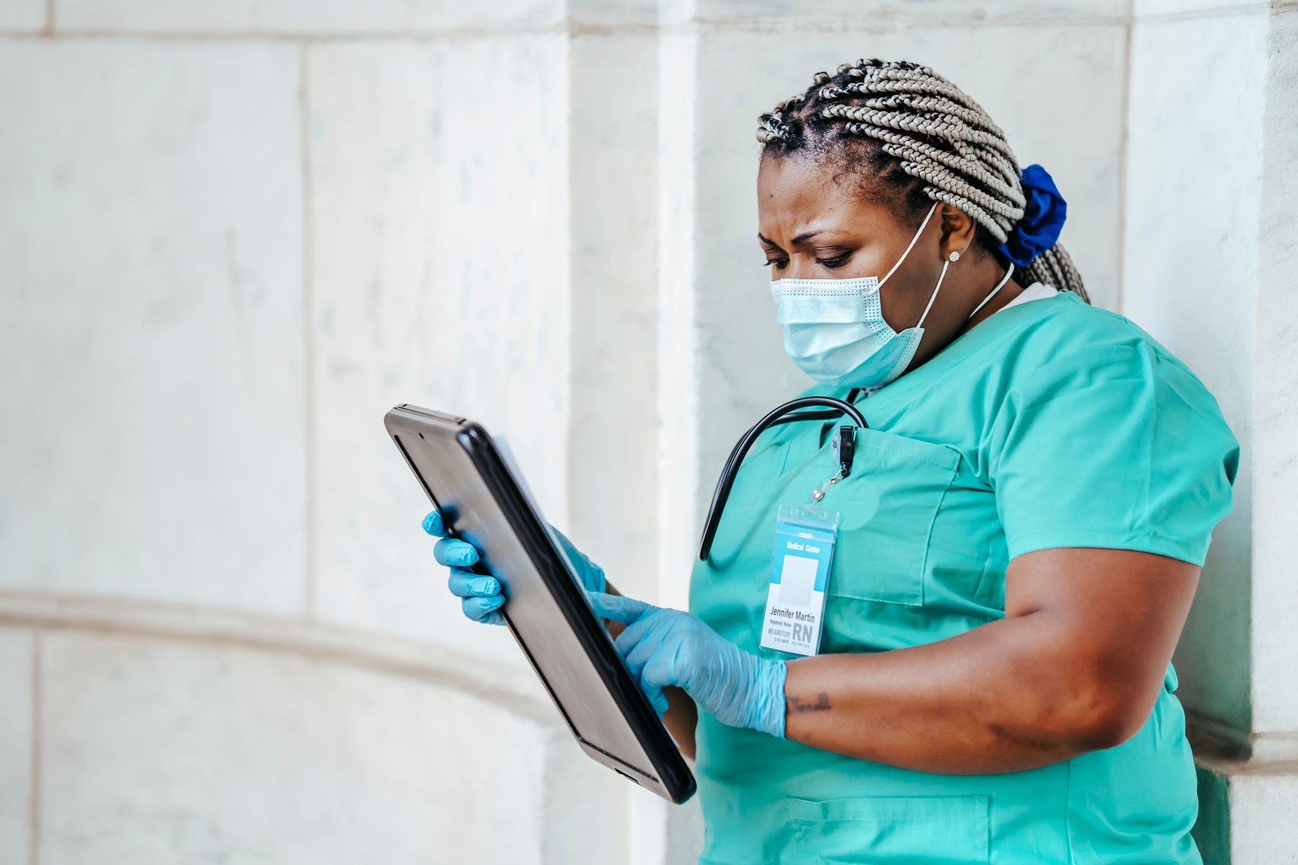 Patient using an accessible hospital website on a tablet with a caregiver nearby
