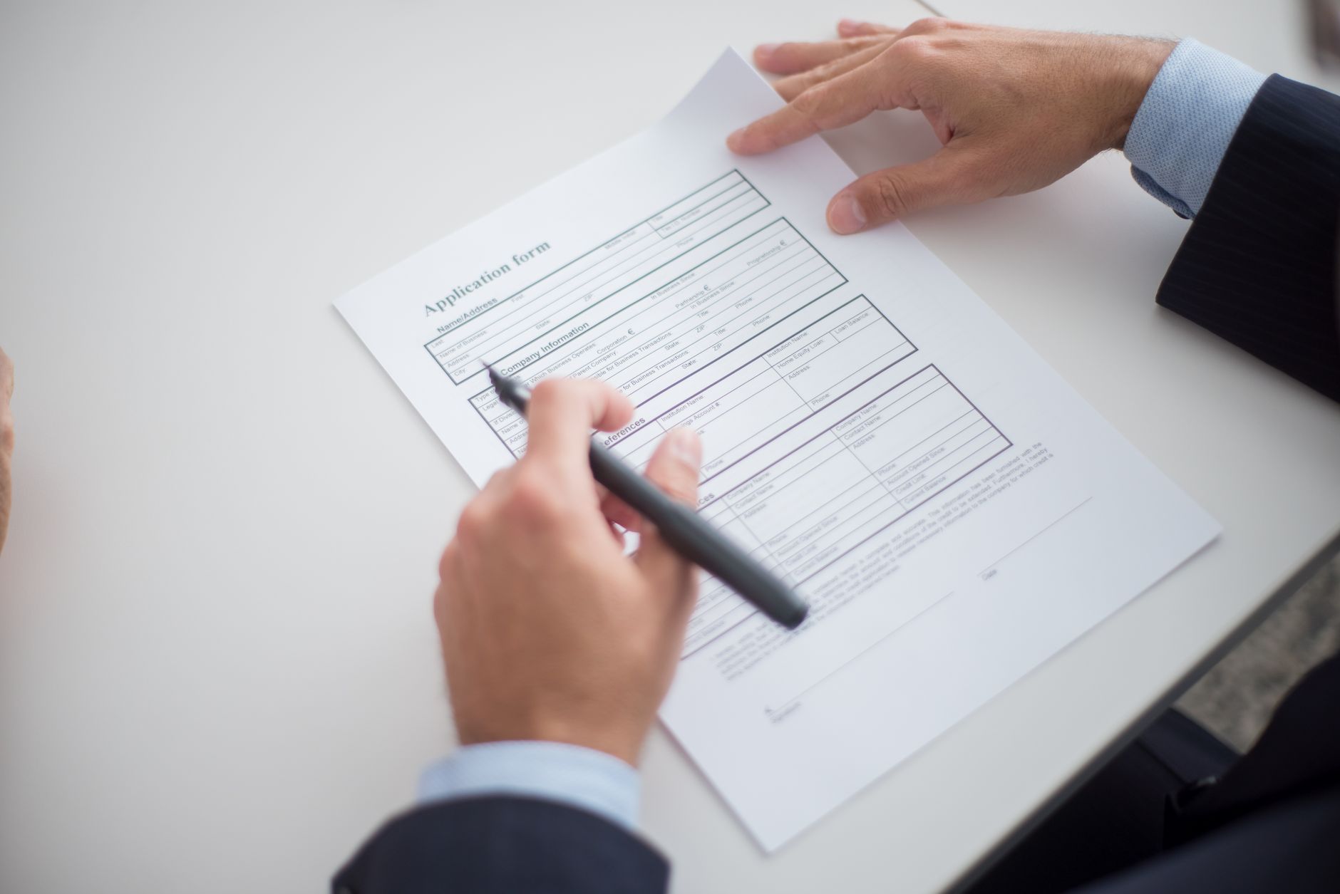 Job applicant using a laptop with assistive technology while completing an online application form