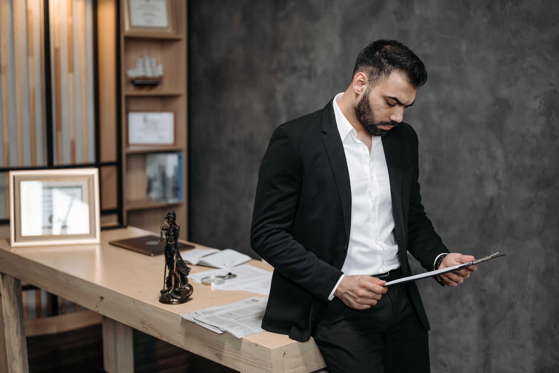 Attorney and client reviewing an accessible website on a laptop in an office setting