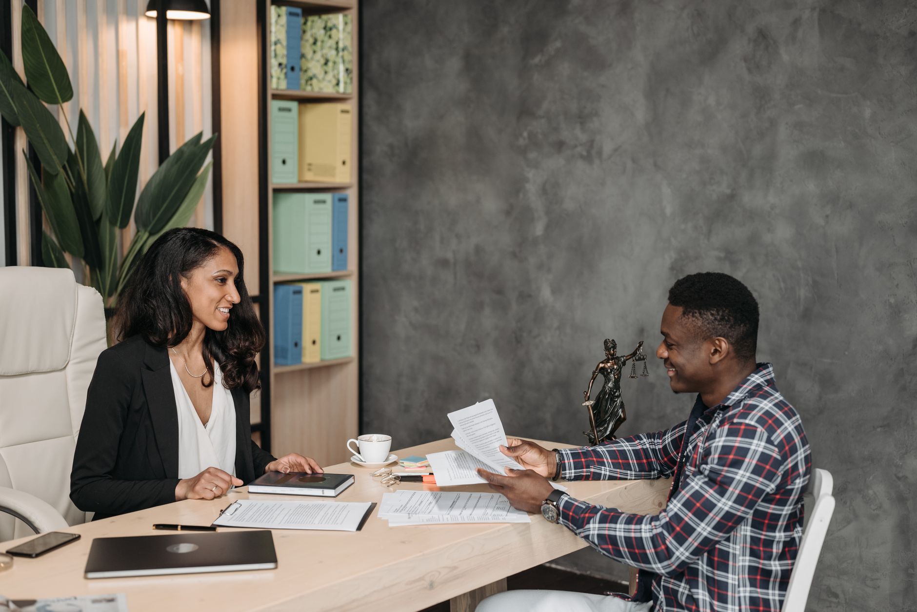 Attorney and client reviewing an accessible website on a laptop in an office setting