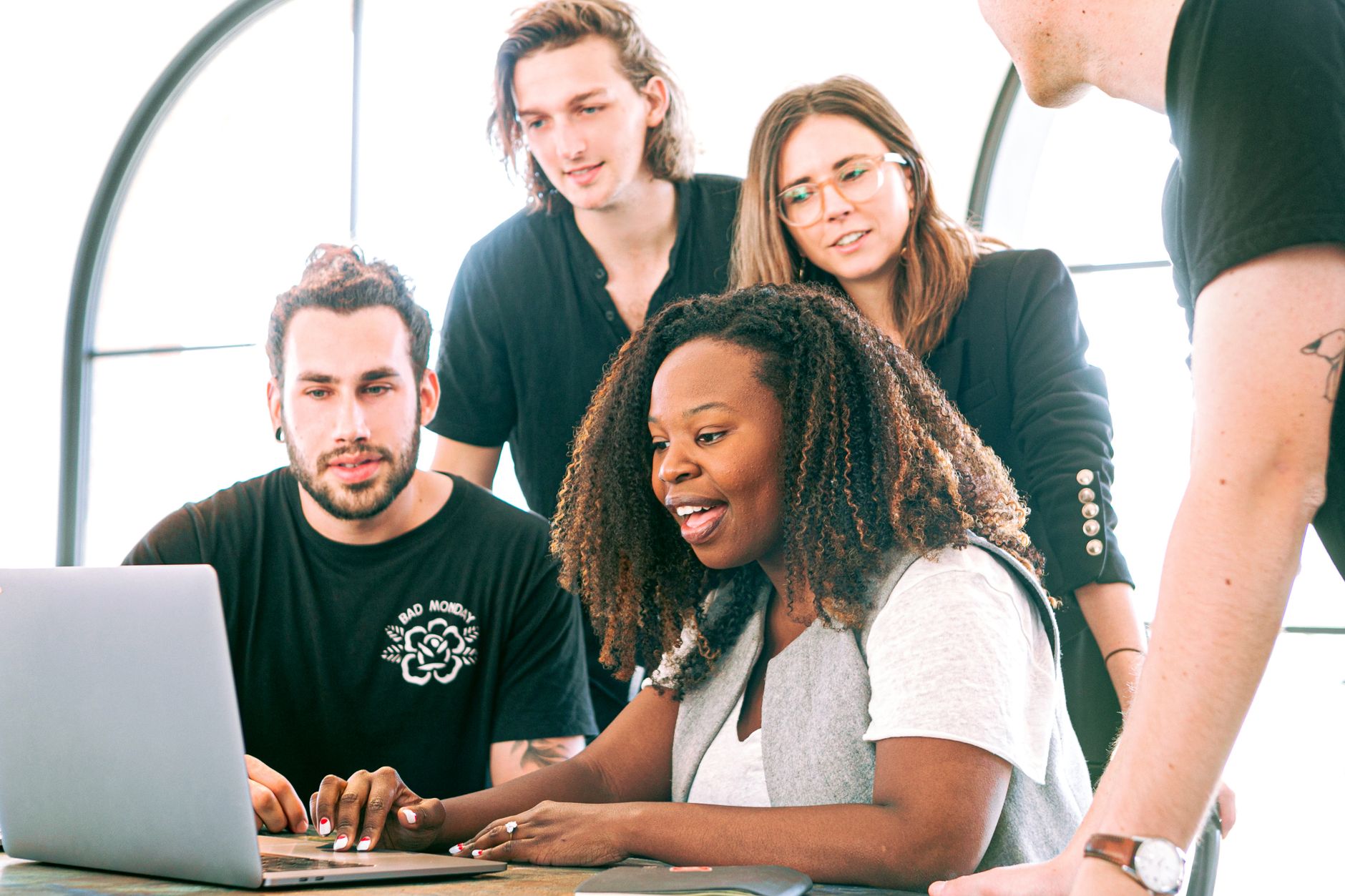 SaaS product team reviewing accessibility issues on a laptop during a sprint planning meeting