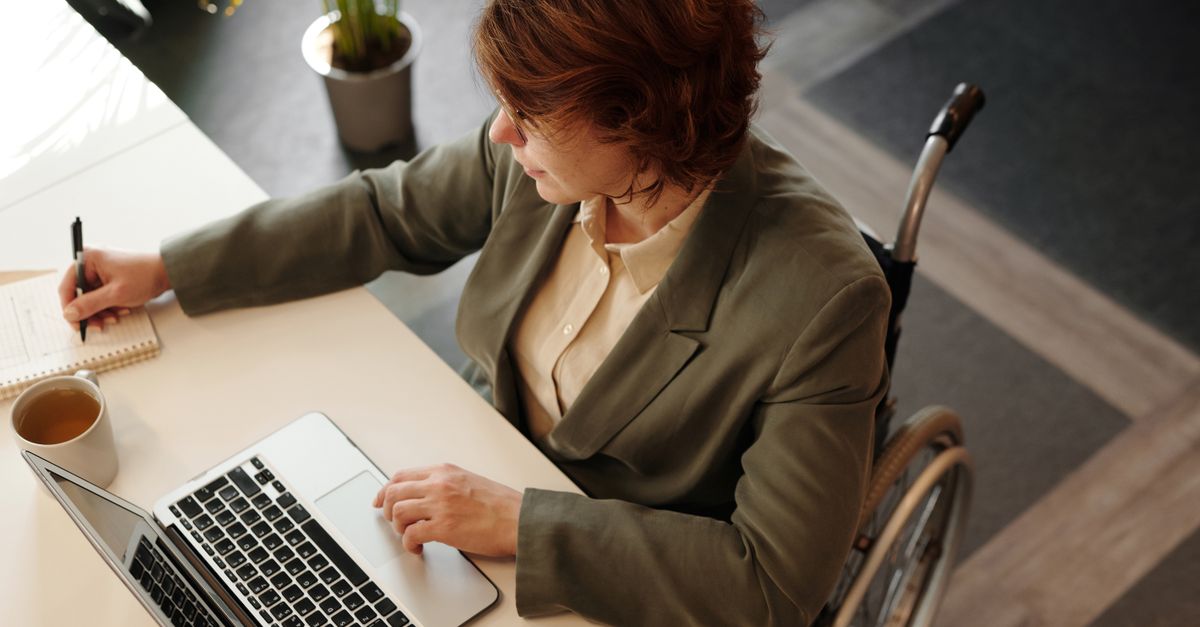 Accessibility specialist reviewing WCAG 2.2 requirements on a laptop