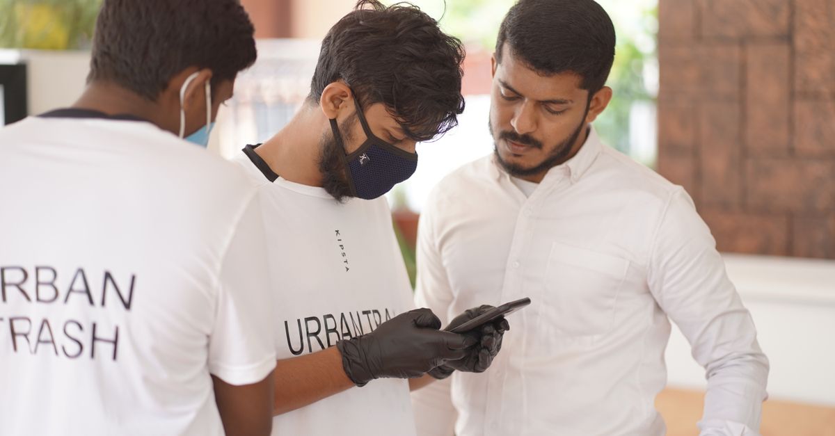 Developer and accessibility specialist reviewing a mobile app on iPhone and Android devices