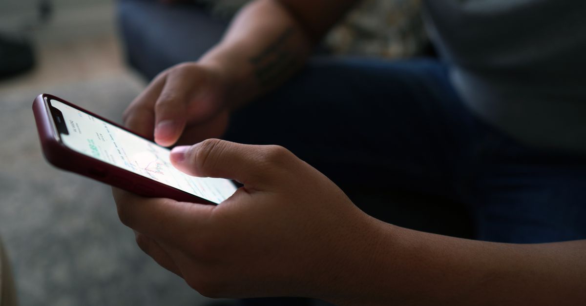 Developer reviewing mobile app accessibility compliance on iOS and Android devices