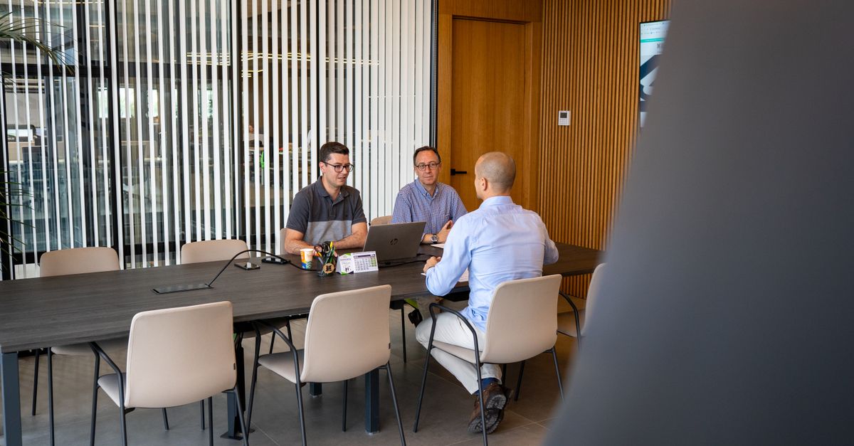 Team reviewing website and mobile app accessibility fixes on screens