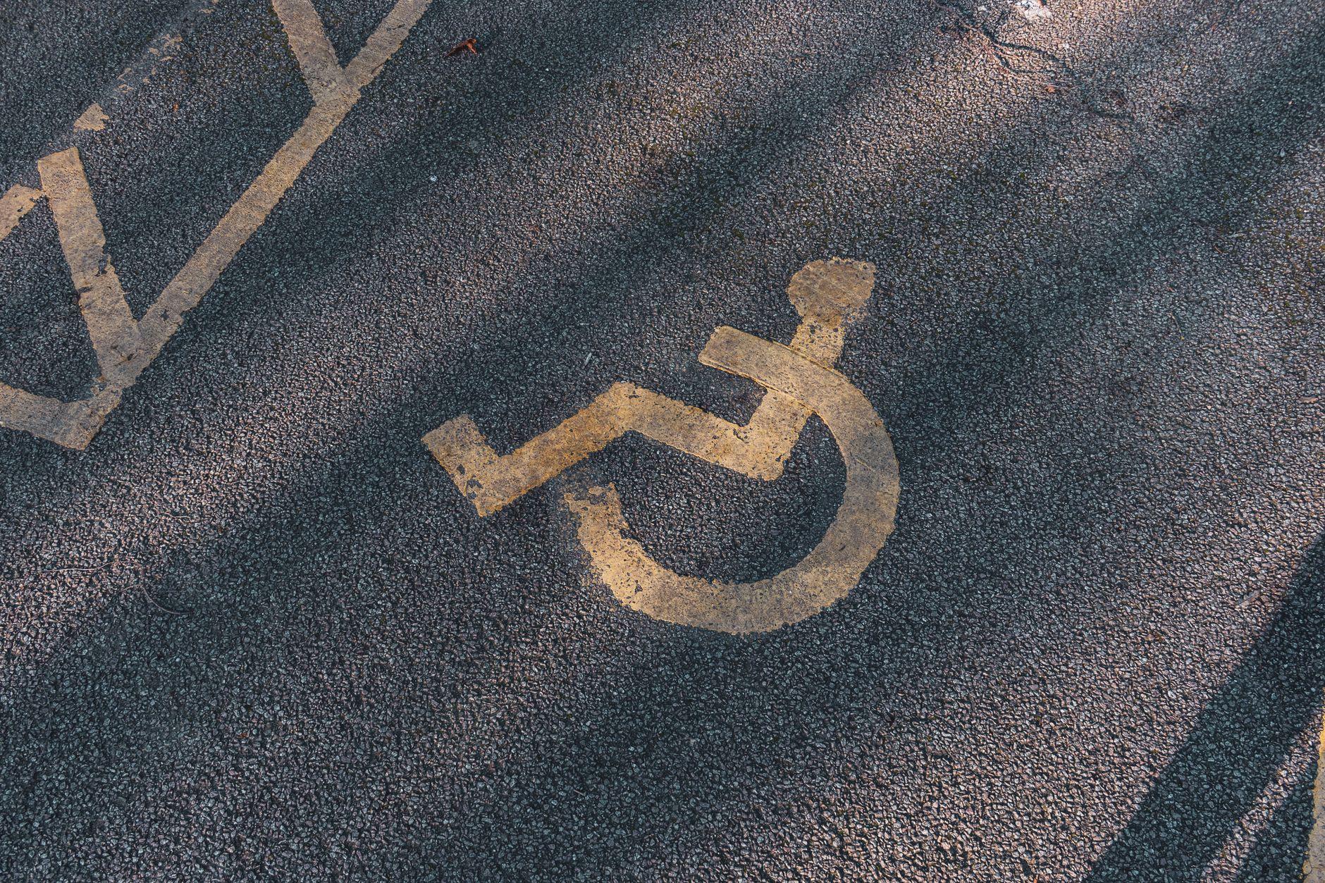 Person adjusting website accessibility settings on a laptop with a visible accessibility widget panel