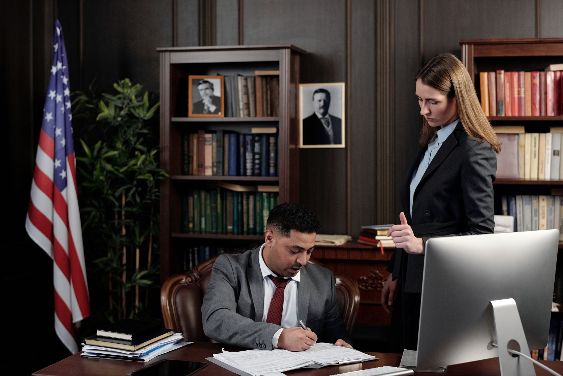 Business professional reviewing a website accessibility compliance report on a laptop with legal documents nearby