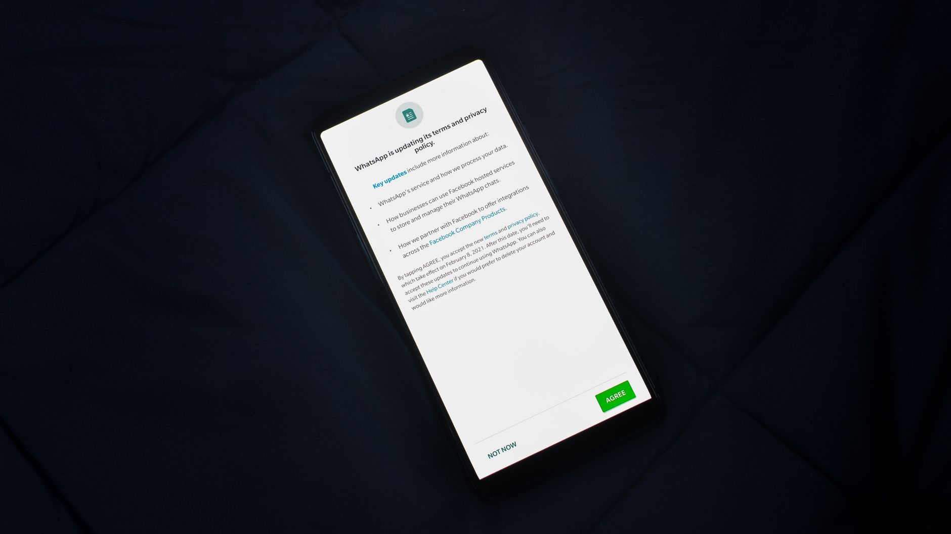 Person reviewing a cookie consent settings panel on a laptop with a checklist document beside it