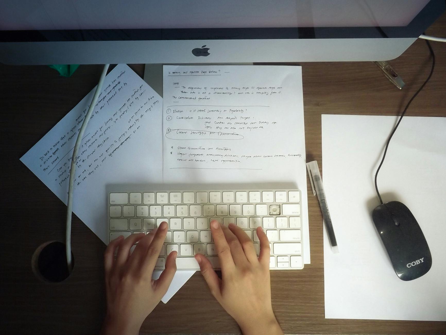 Person reviewing a PDF accessibility checklist on a laptop with notes and a document open