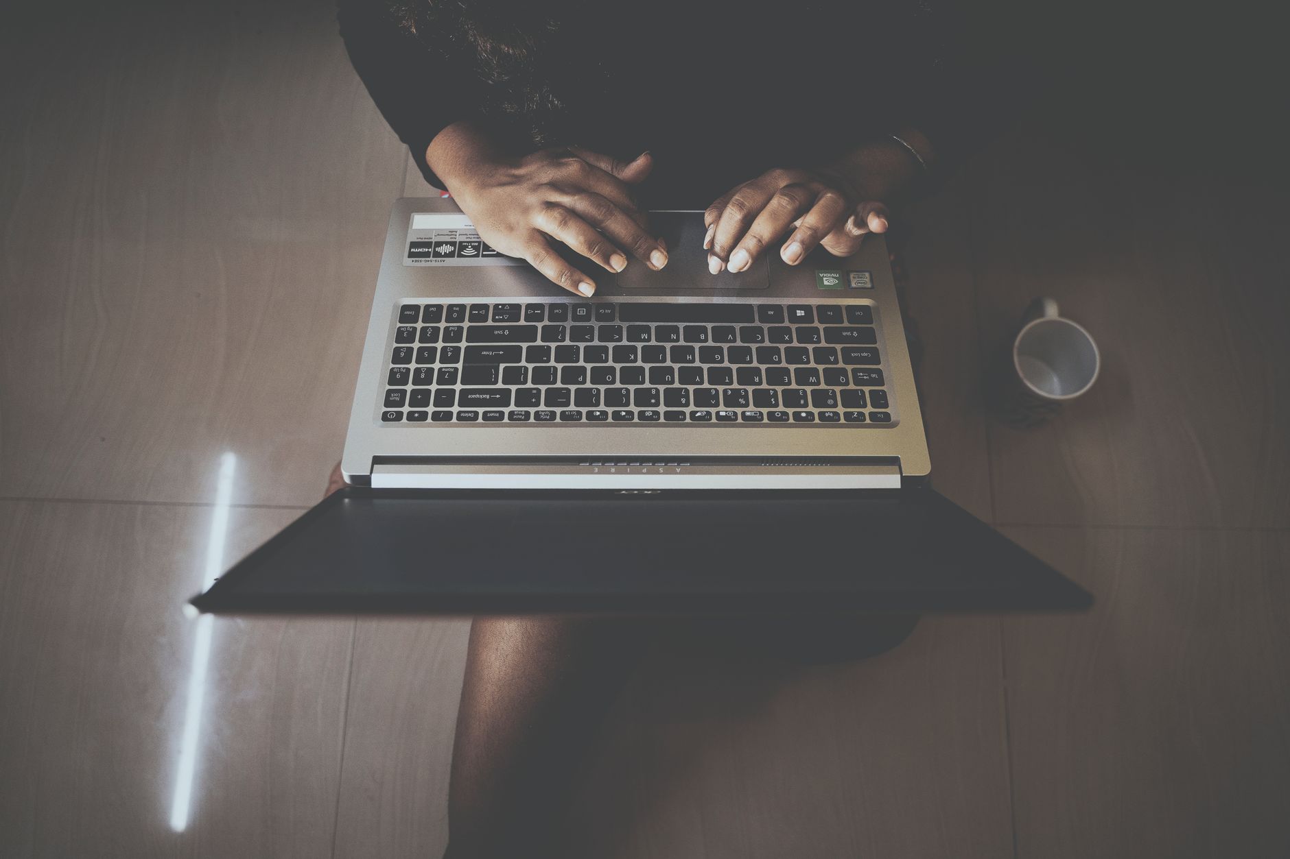 Person using a laptop with an accessibility settings panel visible, representing inclusive web design in Lithuania