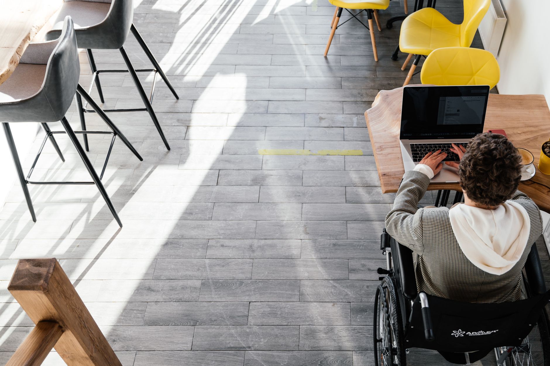Person using a laptop with an accessibility settings panel visible, representing inclusive web design in Lithuania
