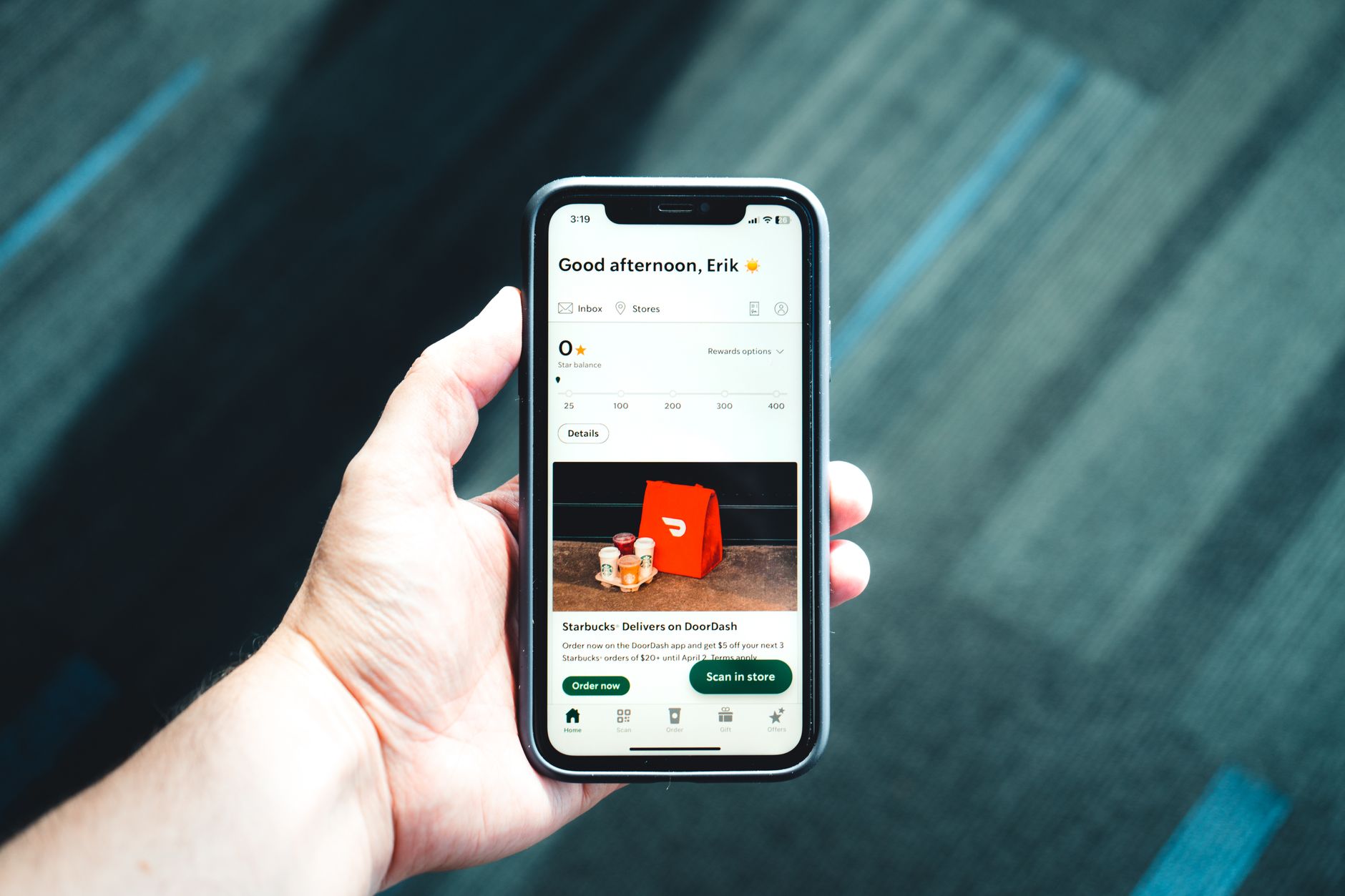 Accessibility tester reviewing a mobile app interface with a checklist on a desk
