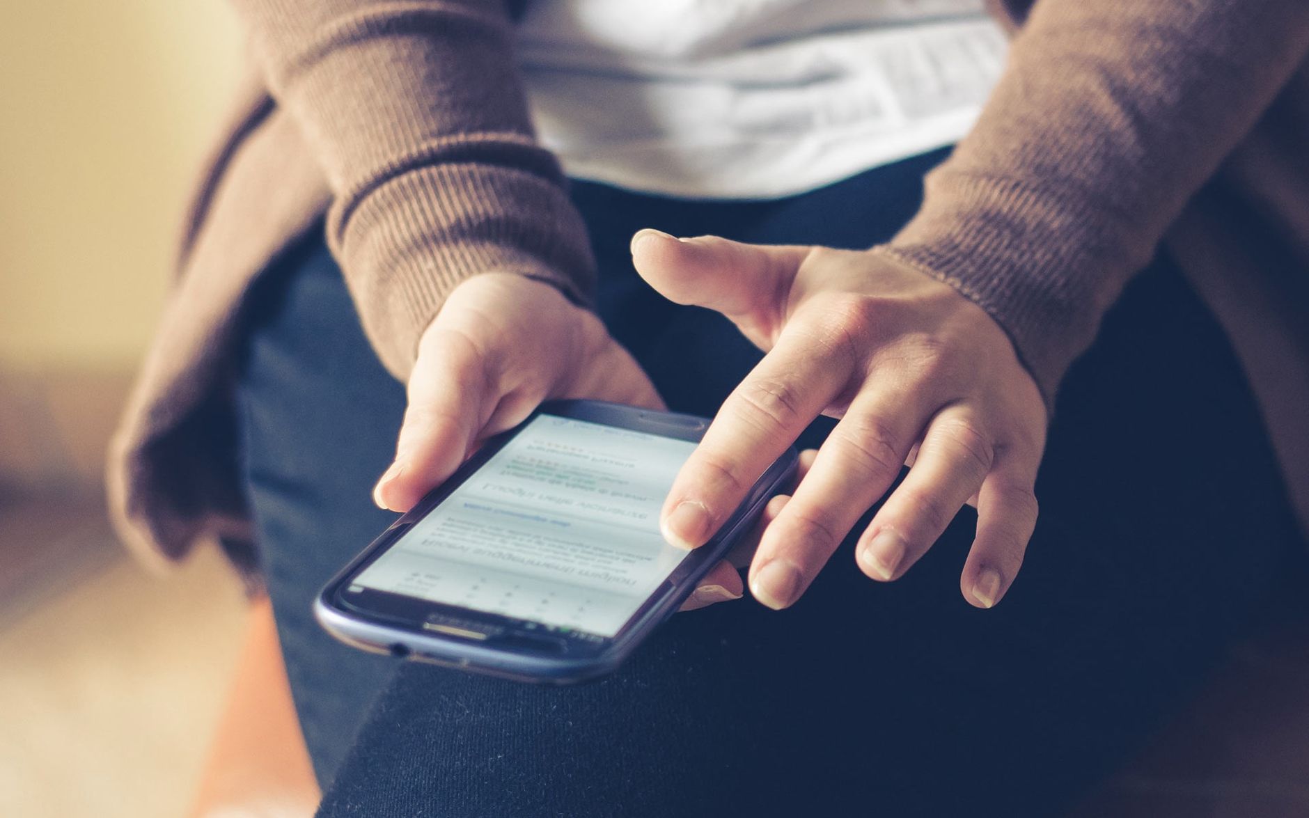 A person using a mobile banking app with accessibility features enabled on a smartphone