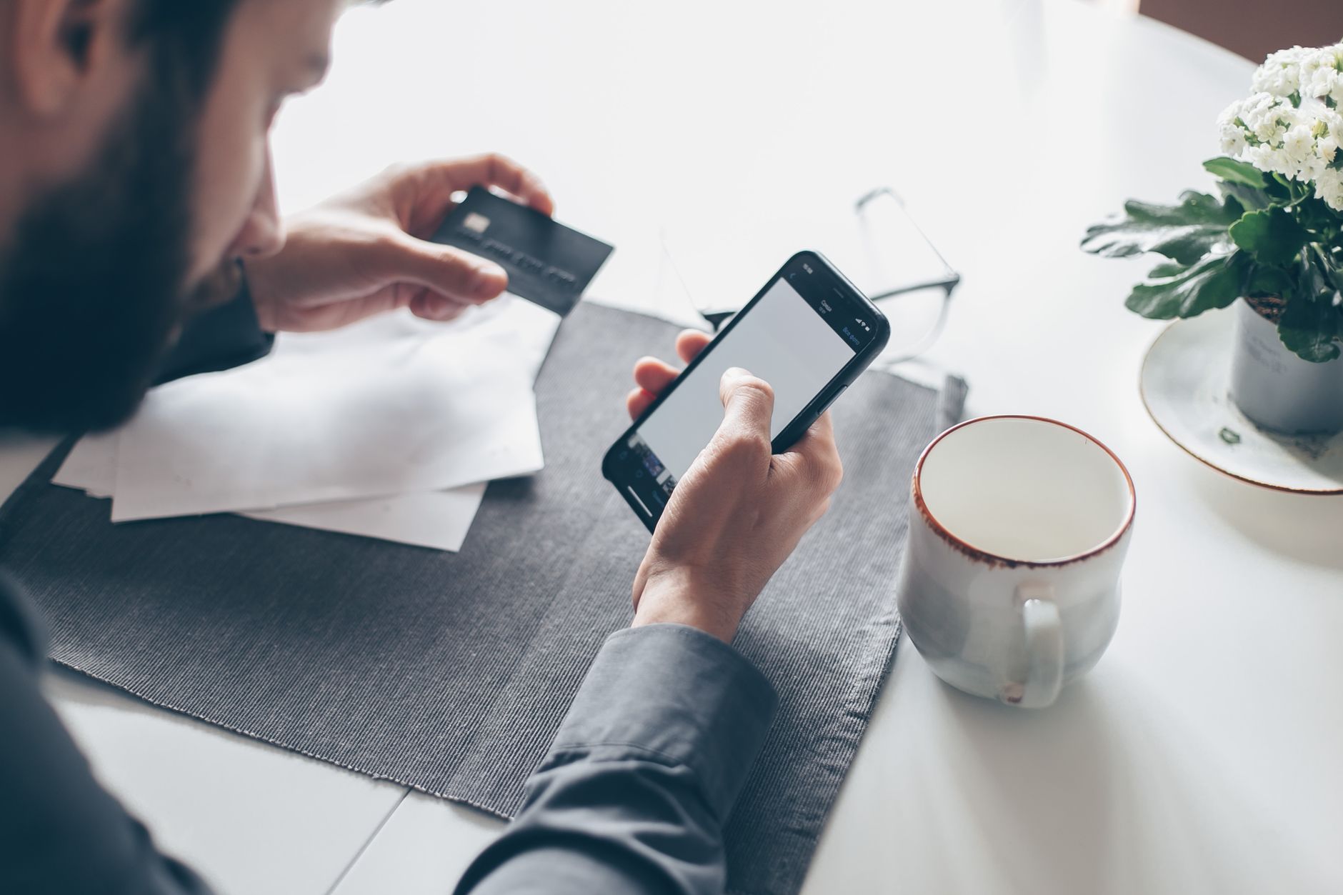 A person using a mobile banking app with accessibility features enabled on a smartphone