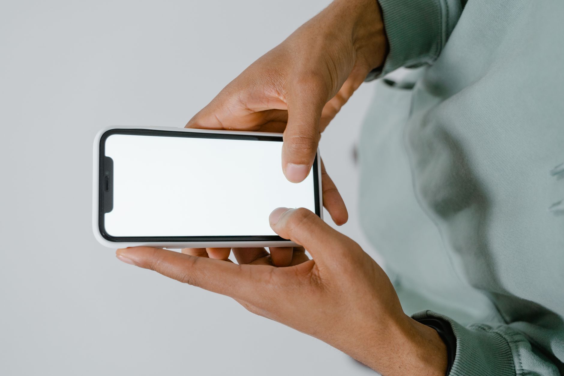 A person using a smartphone movie ticket app with accessibility options visible on screen