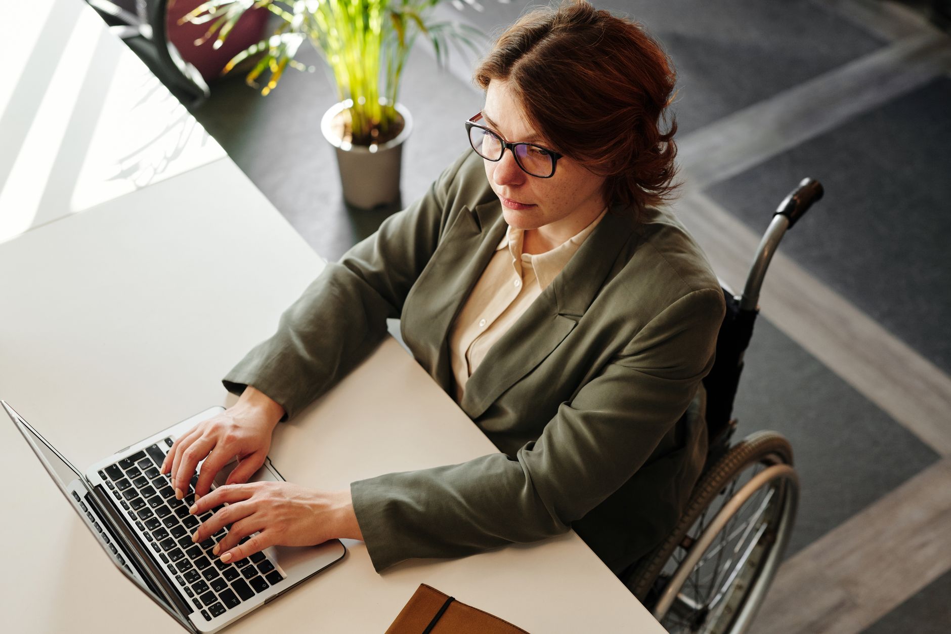 Content strategist reviewing accessibility-focused niche content outlines on a laptop