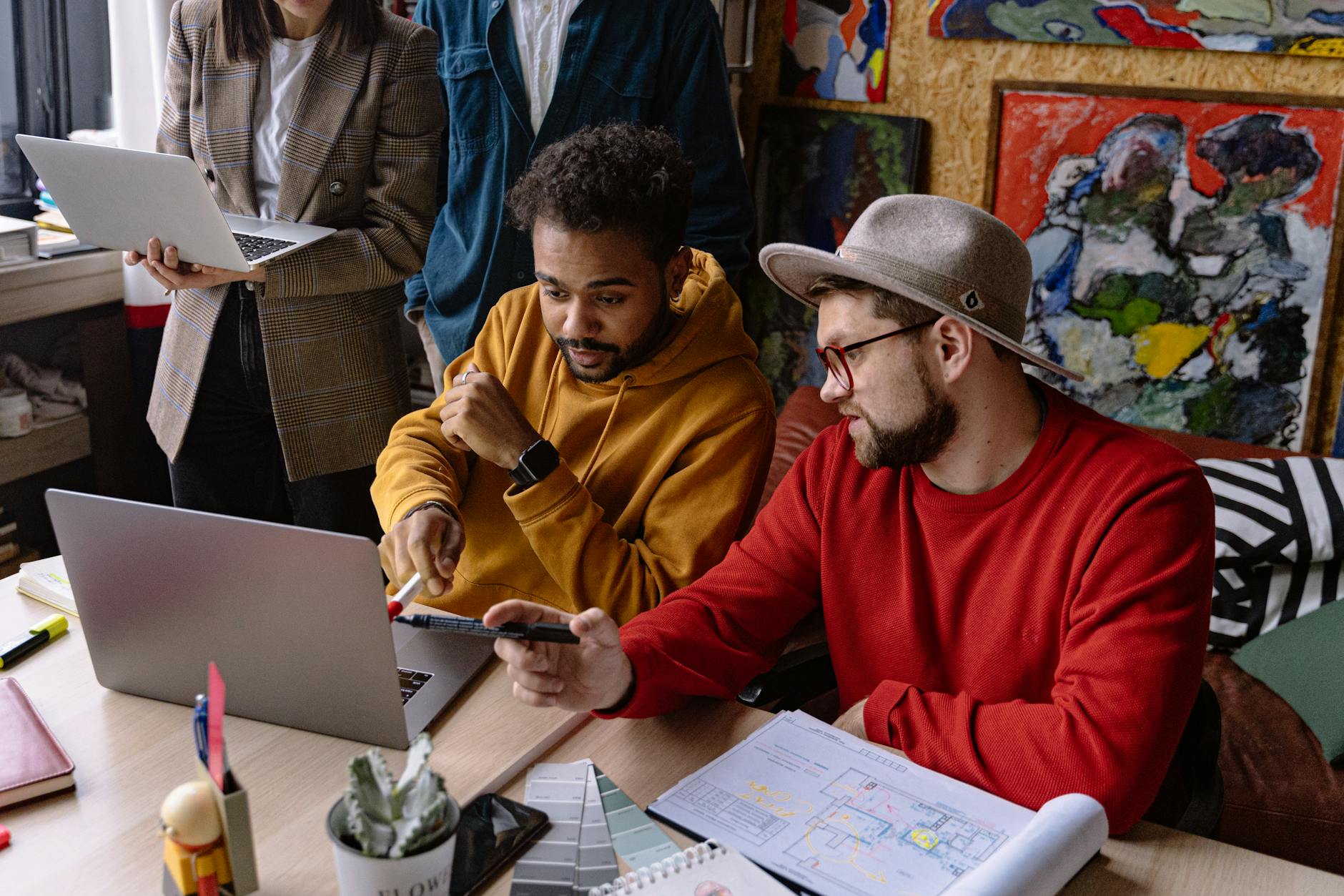 Designer reviewing accessibility annotations and color contrast in a Figma interface on a laptop