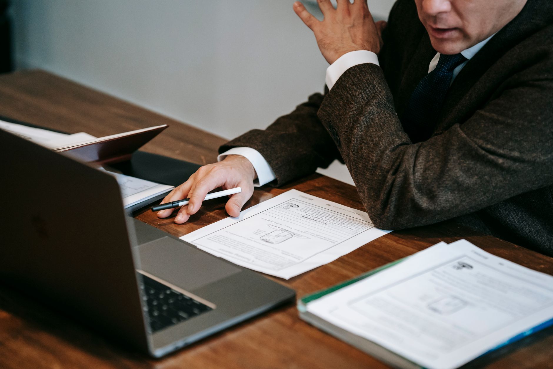 Compliance professional reviewing EU accessibility requirements on a laptop with legal documents on a desk