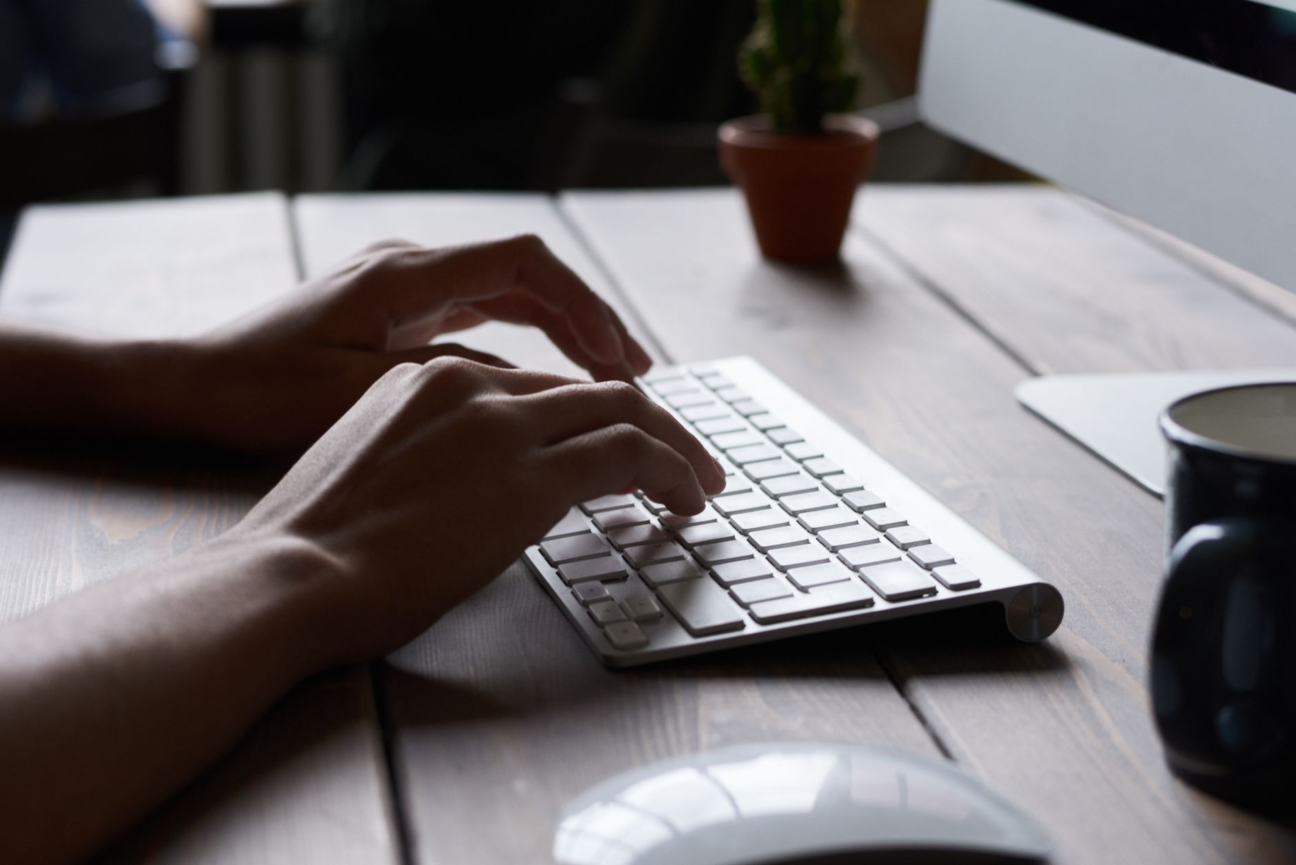 Diverse employees collaborating in a modern office with laptops and accessible technology