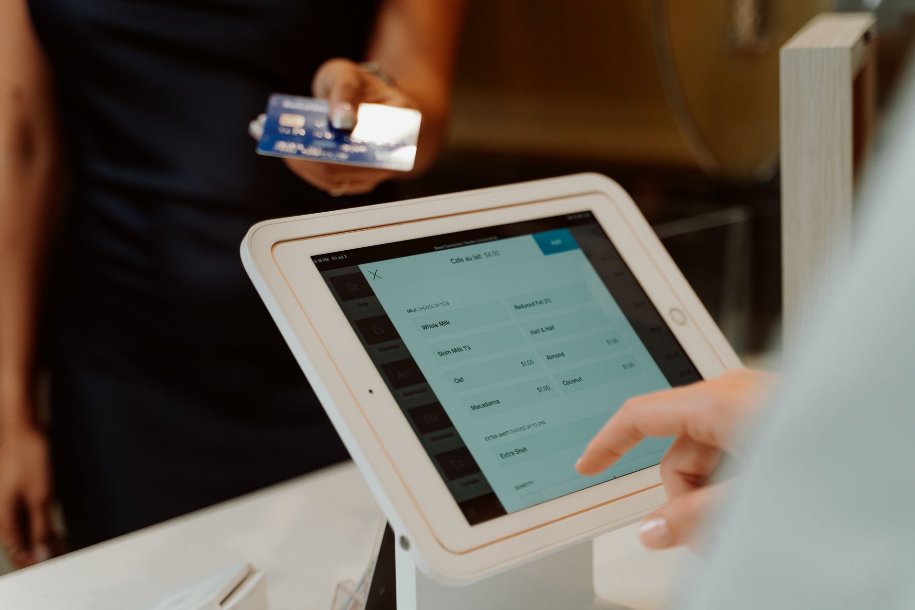 Person comparing prices on an accessible e-commerce website using a laptop and a phone
