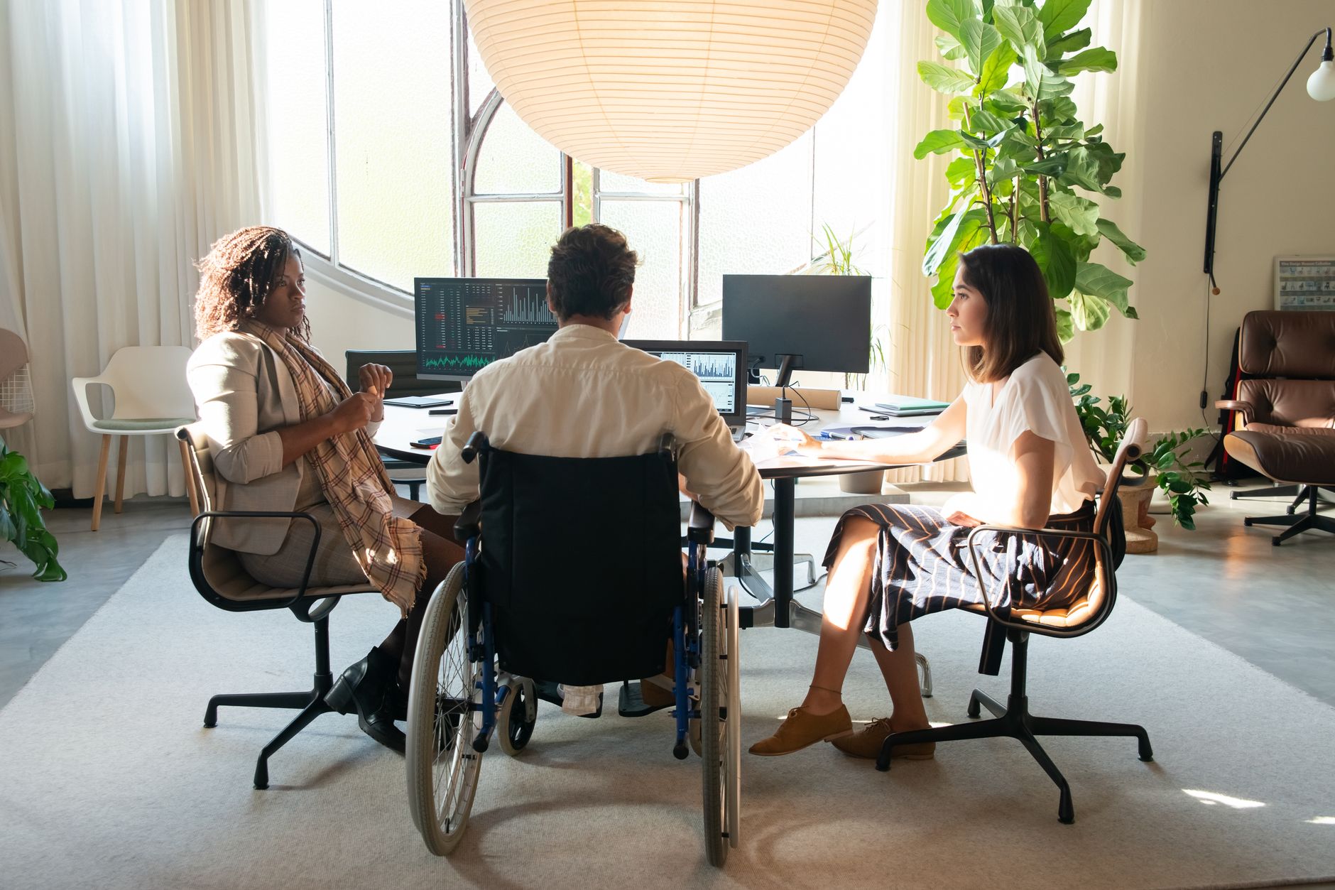 Accessibility consultant reviewing a VPAT checklist with a product team in a meeting room