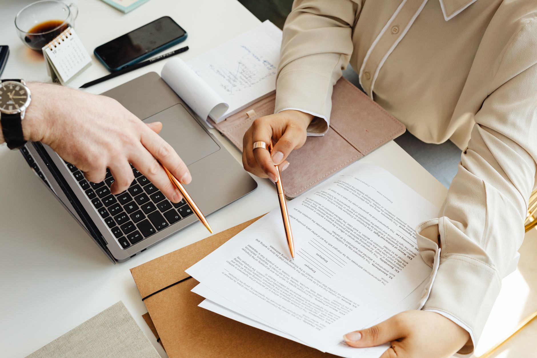 Federal contractor reviewing a VPAT accessibility conformance report on a laptop with procurement documents
