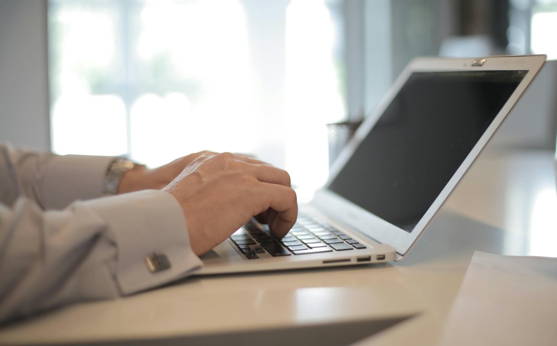 Accessibility specialist reviewing WCAG checklist on a laptop with a website open
