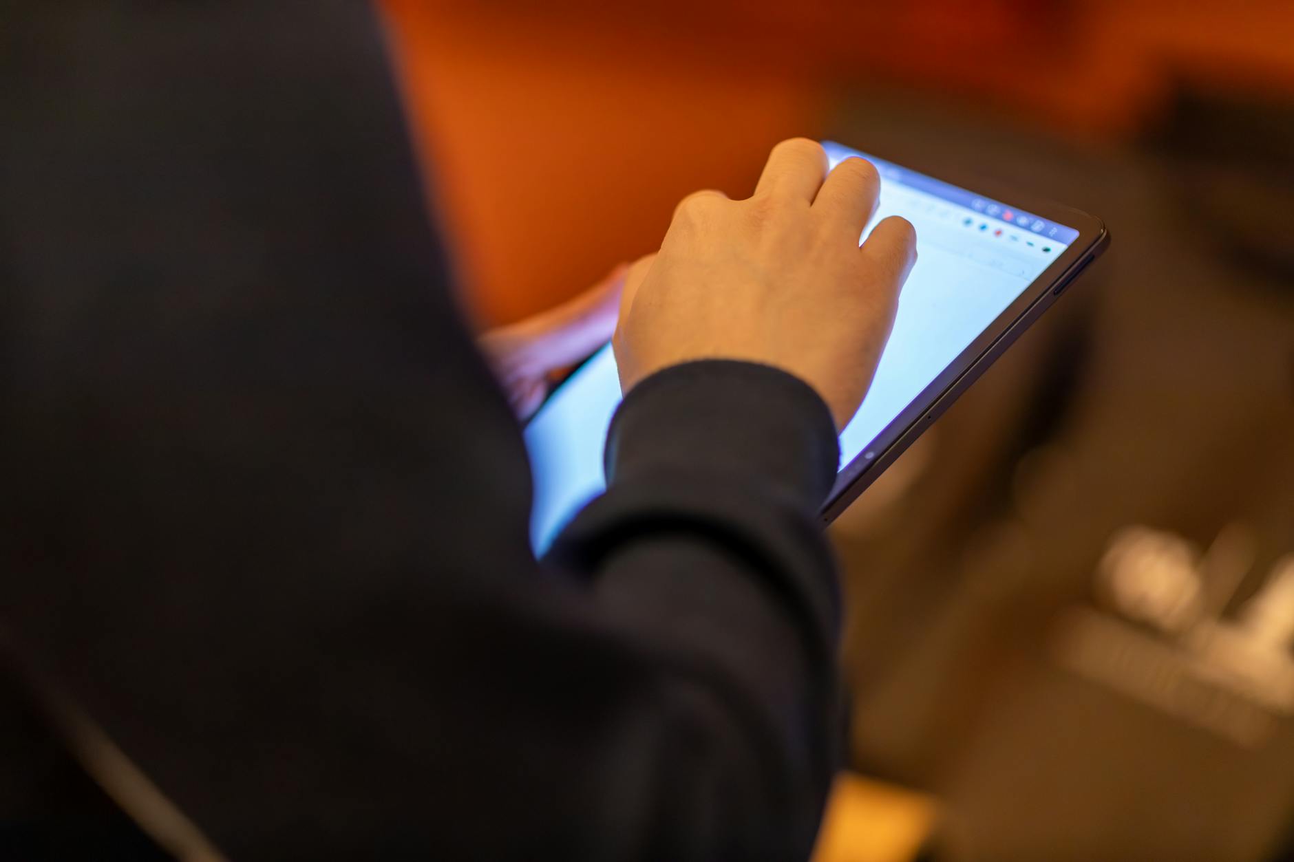 Person using a laptop with accessibility settings and assistive technology on screen