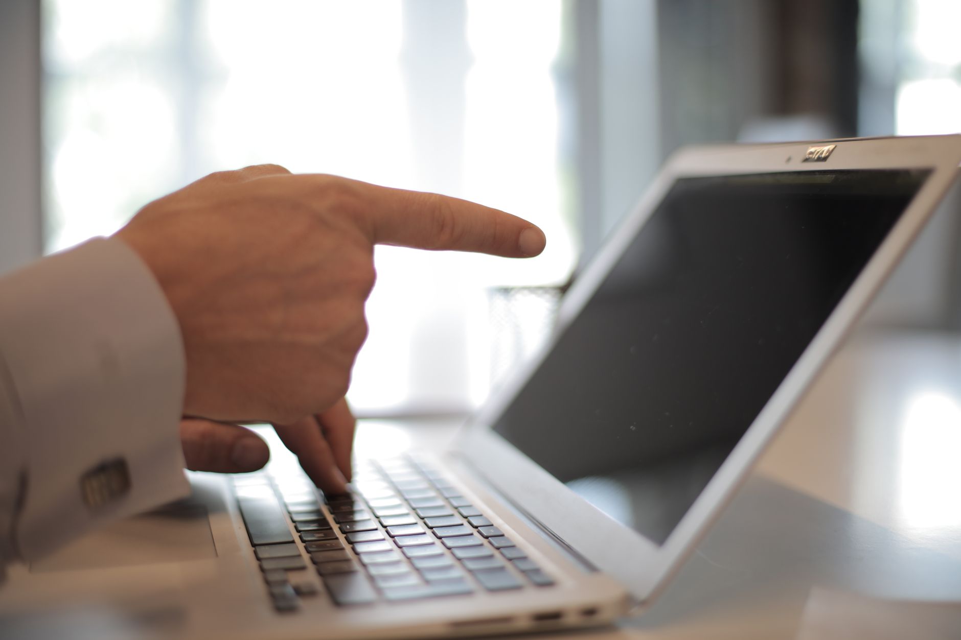 Developer reviewing website accessibility issues on a laptop with code and audit checklist visible