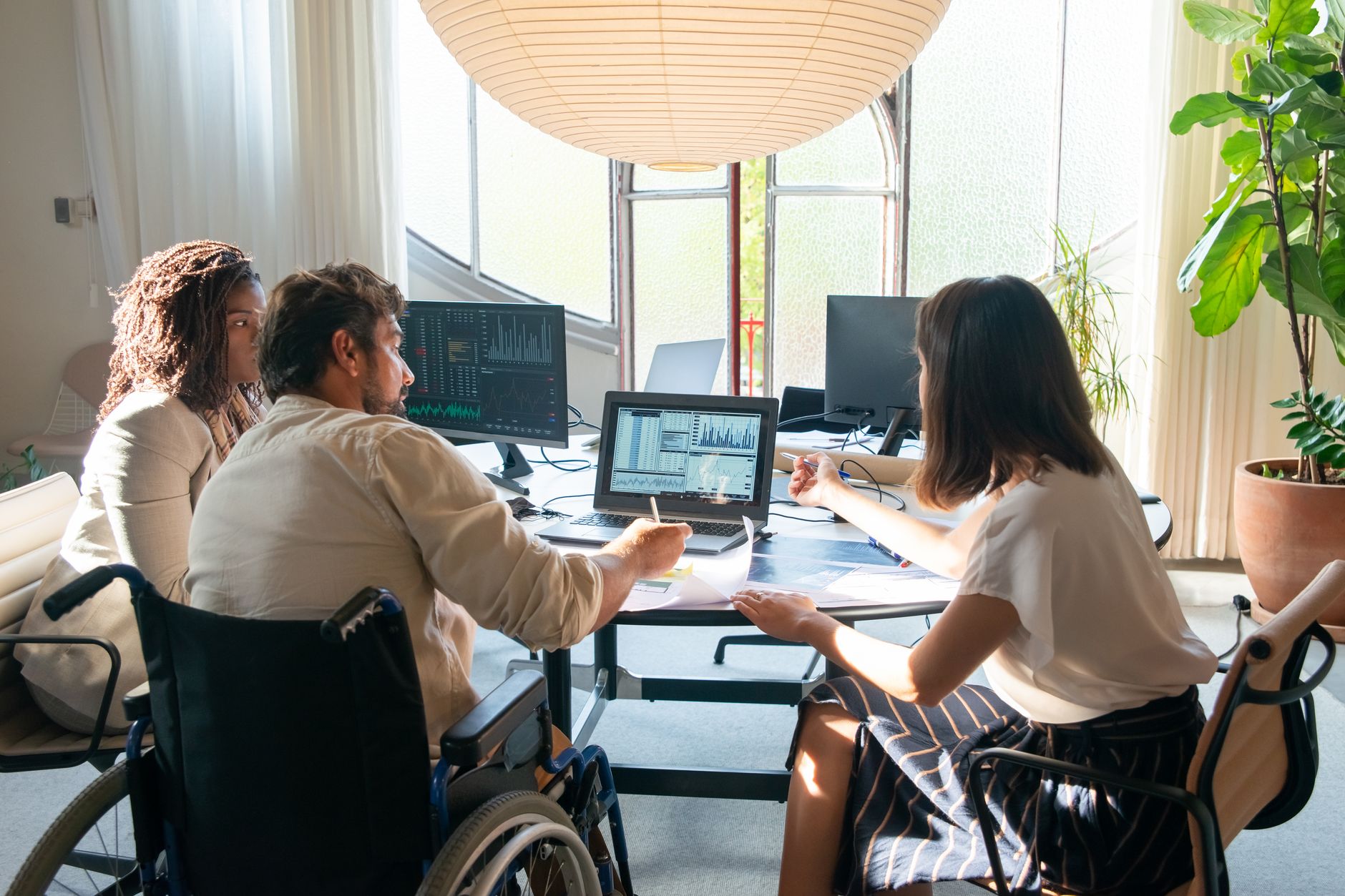 Developer reviewing website accessibility issues on a laptop with code and audit checklist visible