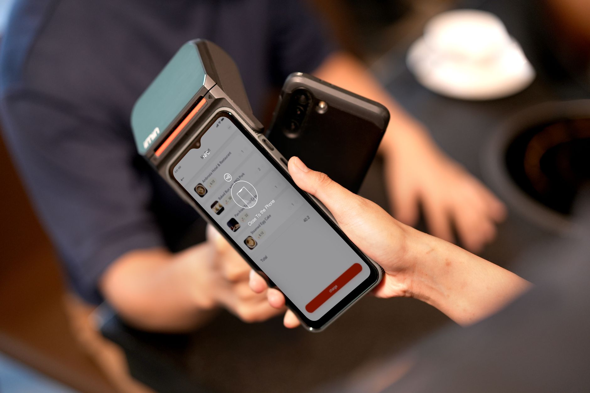 Person paying online with a laptop and a smartphone on a desk, showing multiple payment options